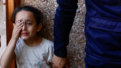 A girl mourns the death of members of the Samour family, who were killed in Israeli strikes on their house in Khan Younis in the southern Gaza Strip. Reuters