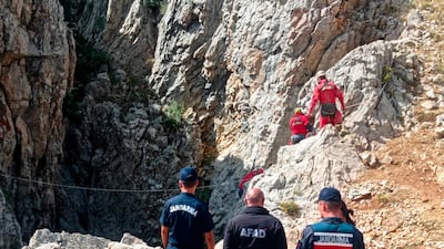 European Cave Rescue Association (ECRA) members and Turkish gendarmerie officers stand next to the entrance of Morca cave near Anamur, southern Turkey. AP