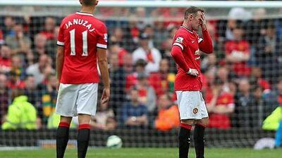 Wayne Rooney, right, of Manchester United looks dejected during the Barclays Premier League match between Manchester United and Swansea City at Old Trafford on August 16, 2014 in Manchester, England. (Photo by Alex Livesey/Getty Images)