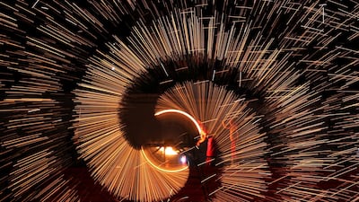 Folk artists throw molten iron to create sparks during an event to celebrate the Chinese Lunar New Year, in Shangqiu, Henan province, China. Reuters