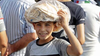 A young boy leaves a bakery with a bag of bread in Lebanon's southern city of Sidon. AFP