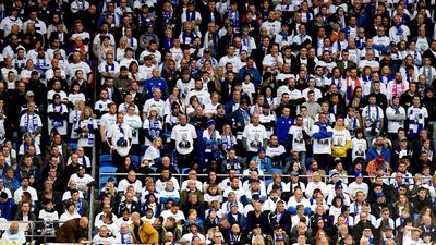 Leicester City fans in the stands wearing Vichai Srivaddhanaprabha shirts during the English Premier League soccer match between Cardiff City and Leicester City at the Cardiff City Stadium, Cardiff. Wales. AP