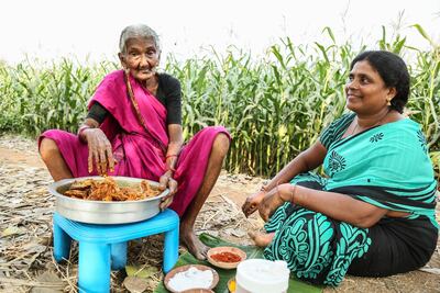 Karre Masthannamma,106 years old, poses for a picture next to the traditional fish recipe she cooked with her Grandaughter Rajni in Gudivada, India. Getty Images