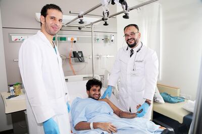 Specialist orthopaedic surgeon Dr Mohammad Ali (left) with lift engineer Flertin Baby, 33, and consultant orthopaedic surgeon Dr Hassan Badawi (right) at Rashid Hospital in Dubai. Courtesy: DHA