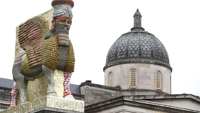 Michael Rakowitz's The Invisible Enemy Should Not Exist, pictured against the National Gallery in London, is a replica of an ancient lamassu made of thousands of date syrup cans / EPA