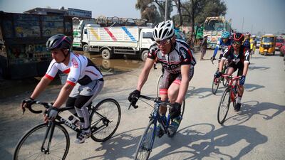 Men cycle during the contest for Peace Cup on the first day of reduction in violence between Afghan Government and Taliban. EPA