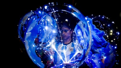 A balloon vendor is seen outside of the Argentine Football Association headquarters. Reuters