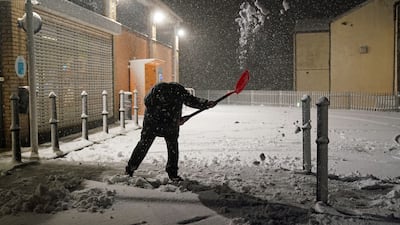 A man clears snow in Tow Law, County Durham. PA
