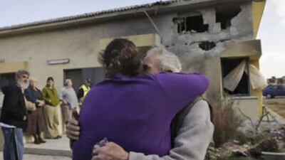 Israelis comfort each other after a rocket, fired by Palestinian militants from within the Gaza Strip, hit their house in Tkuma, near the southern Israeli town of Netivot, on Dec 24 2008.