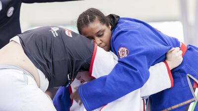 Salwa Al Ali, in blue, from the UAE, fights Juliana Oliveira, from Brazil during a Female White Adult +70 KG match at Al Ain Jiu Jitsu Open Championship. Reem Mohammed / The National