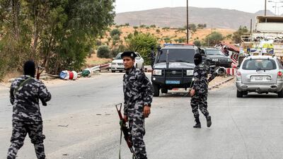 Members of security forces affiliated with the Libyan Government of National Accord (GNA)'s Interior Ministry stand at a make-shift checkpoint in the town of Tarhuna, about 65 kilometres southeast of the capital Tripoli. AFP