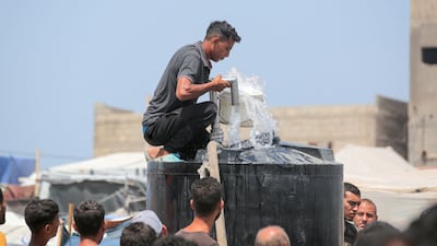 Displaced Palestinians queue for water at a camp near the city of Deir Al Balah, in central Gaza. AFP