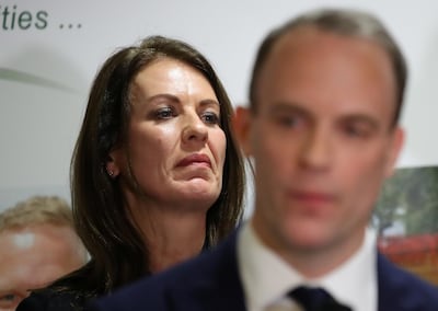 Beaten anti-Brexit candidate Monica Harding looks on as Foreign Secretary Dominic Raab makes a winner's speech in the constituency of Esher and Walton. Reuters