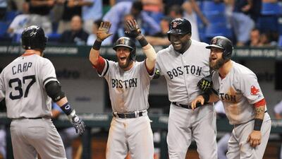 Mike Carp, left, was the hero of the day for the Boston Red Sox. Al Messerschmidt / Getty Images / AFP