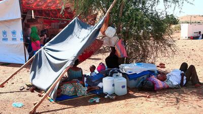 Ethiopian refugees who fled fighting in Tigray province lay in the shade by a shack at the Um Rakuba camp in Sudan's eastern Gedaref province. AFP