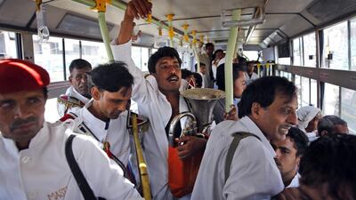 Members of Master Band travel in a bus for work, in New Delhi, India.