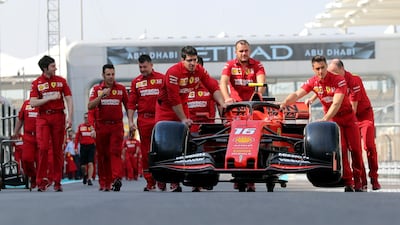 Ferrari mechanics push Charles Leclerc's car on Saturday. AP