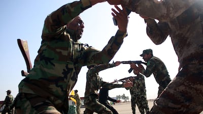 Fighters from a Popular Mobilisation unit take part in an exercise during their graduation ceremony in the southern Iraqi city of Basra, on April 9, 2015.