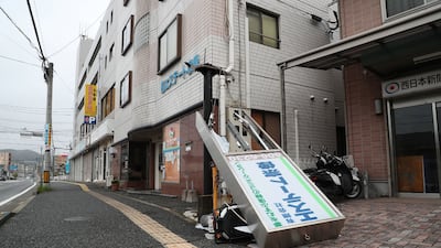 A signboard toppled on to a scooter in south-western Japan. AFP