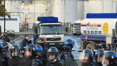 Under the protection of anti-riot police, fuel trucks leave the fuel storage depots blocked by strikers.
