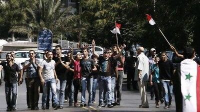 A small group of Assad supporters chant slogans during a demonstration in Damascus against a film ridiculing the Prophet Mohammed.