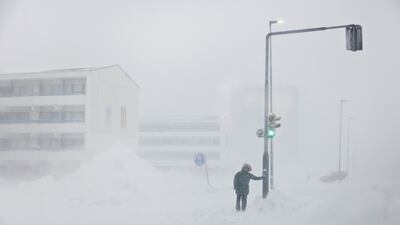 A person stands by a road during a snowstorm in Nuuk, the capital city of Greenland. Reuters