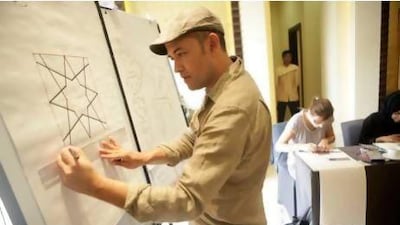 Richard Henry, an artist, teacher and geometer, shares his experience with the students. Sammy Dallal / The National