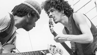 Carlos Santana (right) and bassist David Brown perform at Woodstock '69. Santana will perform again at Woodstock 50 in 2019. Getty Images