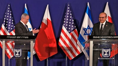 Israeli Prime Minister Benjamin Netanyahu applauds as Bahrain's Foreign Minister Abdullatif Al Zayani looks on during a press conference in Jerusalem. EPA
