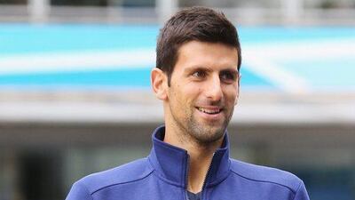 Novak Djokovic arrives with the trophy on Friday to the 2016 Australian Open draw. Michael Dodge / Getty Images