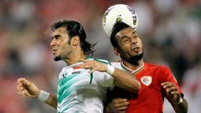 Iraq's Samal Said beats Mohammed Al Balushi to the ball
