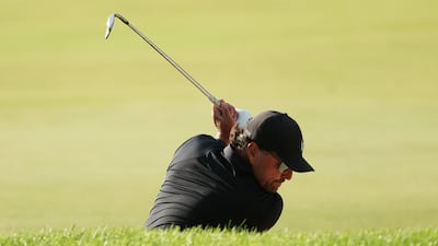 Phil Mickelson plays a shot from a bunker on the 15th hole. AFP