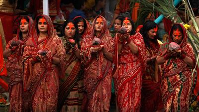 Nepalese women hold coconuts and offer prayers to the setting sun on the banks of the Bagmati River during the Chhath Puja festival in Kathmandu, Nepal. Niranjan Shrestha / AP Photo