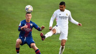 Real Madrid's Casemiro and Dani Escriche of Huesca. AFP