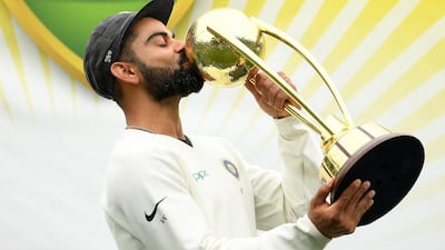 India captain Virat Kohli kisses the Border-Gavaskar Trophy as his team celebrates a 2-1 series victory over Australia following play being abandoned in the fourth Test match in Sydney. EPA