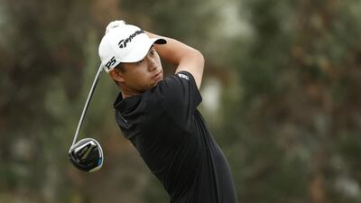 Collin Morikawa plays his shot from the first tee during the final round of the Sony Open in Hawaii. AFP