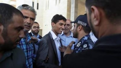 Palestinian ‘Arab Idol’ Mohammed Assaf (centre) is welcomed by a policeman loyal to Hamas upon his arrival in Gaza .