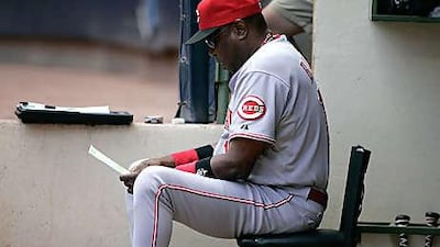 Dusty Baker looks at Cincinnati's line-up card. Tomorrow, major league teams can expand their rosters from 25 to 40 players.