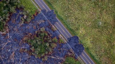 Lava flows across a highway on the outskirts of Pahoa during ongoing eruptions of the Kilauea Volcano in Hawaii. Terray Sylvester / Reuters