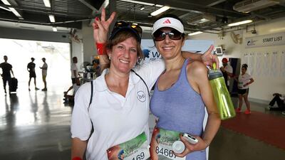 Competitors Lynn Middleton, left, and Nada Zabaneh wind down after taking part in the Wings For Life World Race for spinal cord research held at Dubai Autodrome. The challenging event drew nearly 900 runners to Dubai. Pawan Singh / The National
