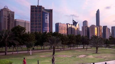 Men playing cricket in the park opposite Abu Dhabi Corniche. Reem Mohammed / The National