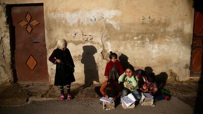Girls write on notebooks in the rebel held besieged Douma neighbourhood of Damascus, Syria. Bassam Khabieh / Reuters