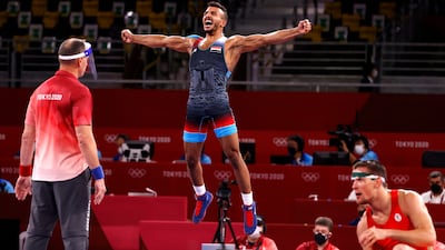 Mohamed Ibrahim Elsayed of Egypt jumps for joy after defeating Artem Surkov to win bronze in the Greco-Roman wrestling.