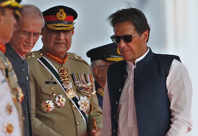 Imran Khan, right, army chief Gen Qamar Javed Bajwa, centre, and then defence minister Pervez Khattaq attend a military parade to mark Pakistan National Day in Islamabad last month. AP