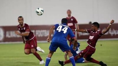Al Wahda's Mahmoud Khamis (26) takes a shot on goal as Kuwait's Fahd Abdulaziz (44) looks on during a friendly football match on July 27.
