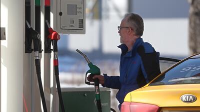 A man fills a car at a petrol station in Russia, which is demanding payment in roubles for its fossil fuels. EPA