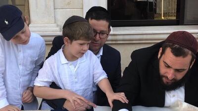 Rabbi Levi Duchman writes first letters in the Torah that was donated by a lady in Switzerland. Photo: Adina Krausz