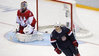 TJ Oshie, right, celebrates scoring the game-winning shoot-out goal for the United States against Russian goaltender Sergei Bobrovski during their men’s ice hockey game on Saturday. Grigory Dukor / Reuters