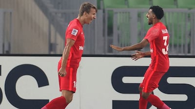 Shabab Al Ahli forward Thomas Lehne Olsen (L) celebrates his opening goal with Hareb Abdullah. AFP