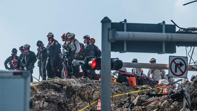 Search and rescue teams look for survivors in the partially collapsed 12-story Champlain Towers South condo building on Monday. AFP